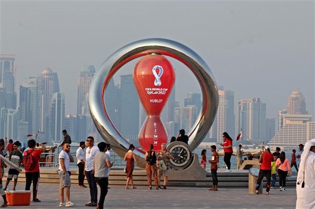 Người dân và du khách chụp ảnh tại điểm đặt đồng hồ đếm ngược tới World Cup 2022 ở Doha (Qatar), ngày 20/10/2022