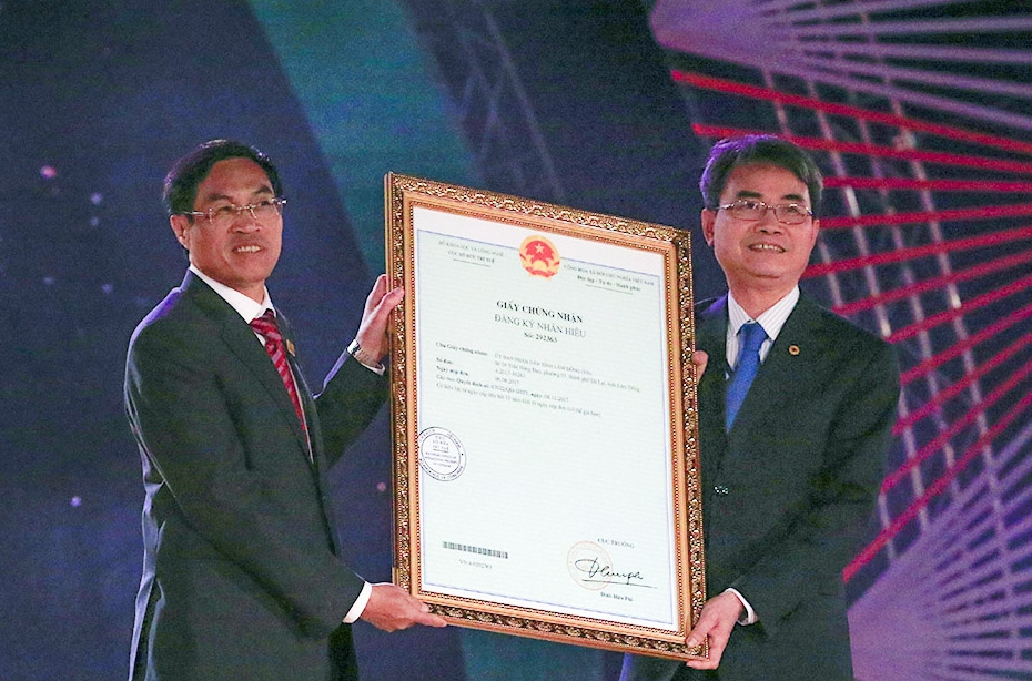 Ông Đinh Hữu Phí – Cục Trưởng Cục Sở hữu trí tuệ, Bộ Khoa học và Công nghệ  trao Quyết định cấp Giấy chứng nhận đăng ký nhãn hiệu “Đà Lạt - Kết tinh kỳ diệu từ đất lành” cho Chủ tịch UBND thành phố Đà Lạt Võ Ngọc Hiệp