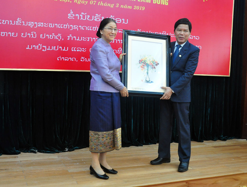 Đồng chí Nguyễn Xuân Tiến, Ủy viên Trung ương Đảng, Bí thư Tỉnh ủy Lâm Đồng tặng bức tranh thêu tay- sản phẩm của Đà Lạt cho Đồng chí Pany  Yathotou, Ủy viên Bộ chính Đảng Nhân dân Cách mạng Lào, Chủ tịch Quốc hội nước Cộng hòa Dân chủ Nhân dân Lào