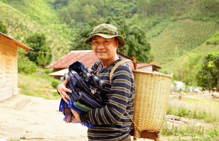 Một thành viên đoàn từ thiện vui mừng với các sản phẩm vừa thu mua. Ảnh: Q.Lâm