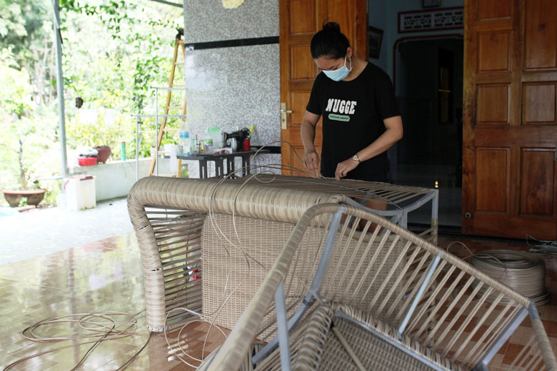 Chị Tạ Thị Thu, thôn Phú Hòa, luôn chấp hành việc đeo khẩu trang ngay khi thực hiện công việc đan lát thủ công mỹ nghệ trong khuôn viên gia đình